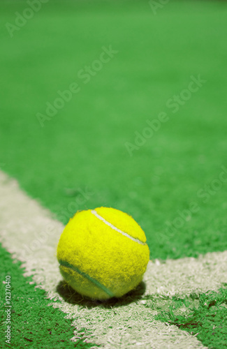 Tennis ball on the court line