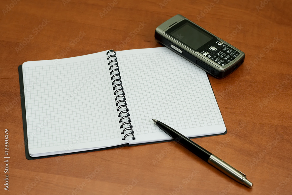 notebook pen and mobile phone on table notebook pen and mobile phone on table
