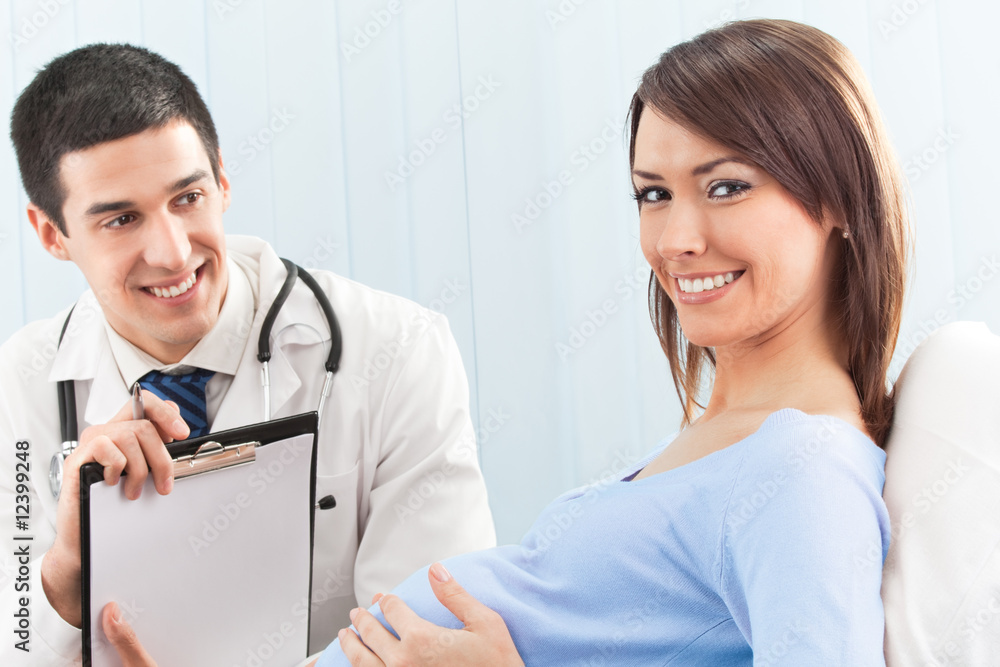 Doctor and pregnant female patient on bed at clinic Doctor and pregnant female patient on bed at clinic
