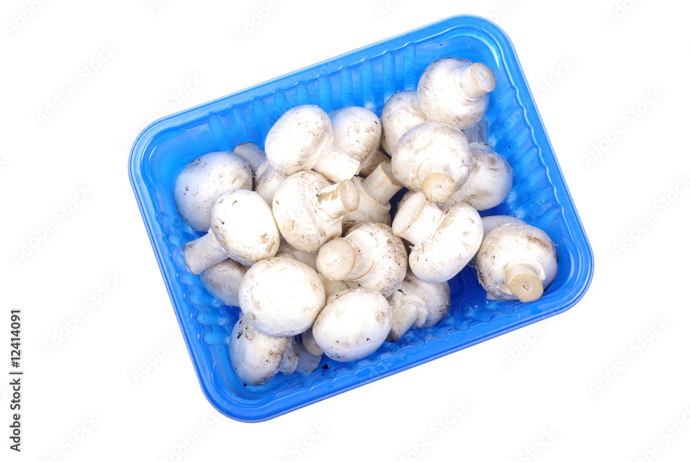 Champignon mushrooms in blue pack isolated on white background. Champignon mushrooms in blue pack isolated on white background.