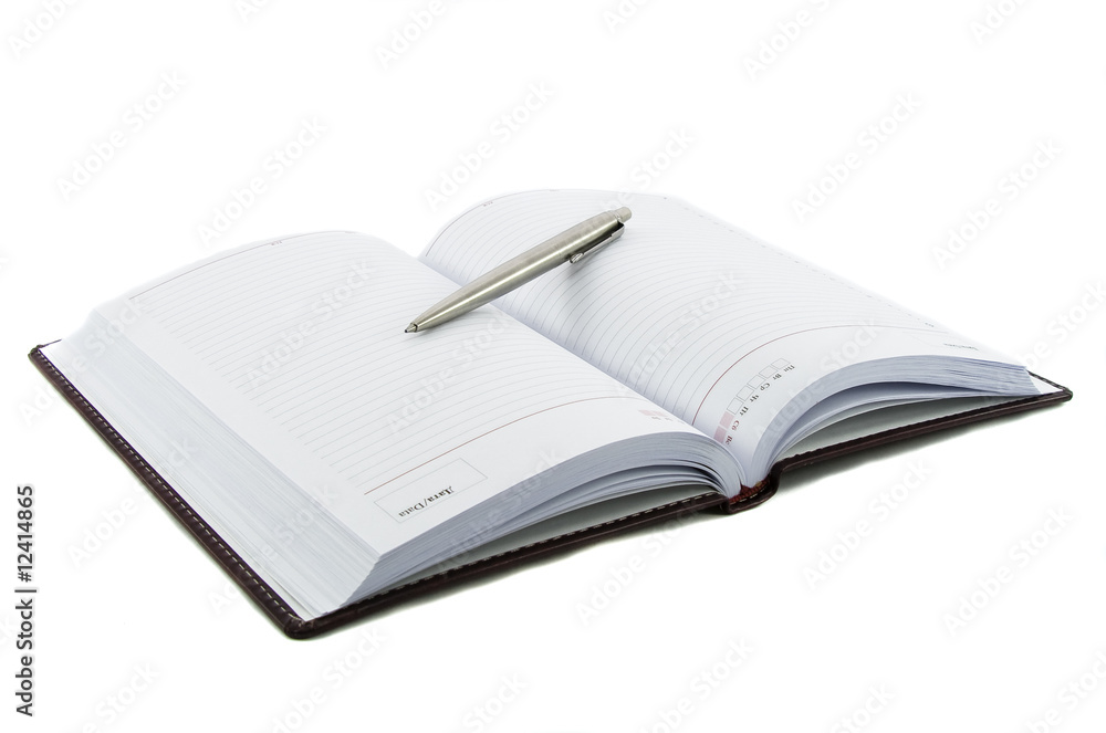 Fototapeta premium Close up noutbook and pen on it isolated over white