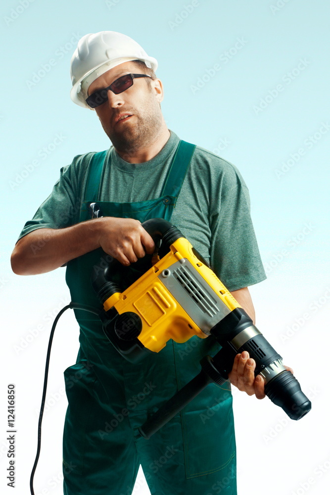 Tired workman hold perforator over white background Tired workman hold perforator over white background
