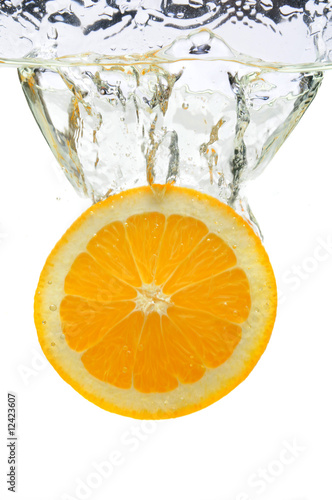 Fototapeta Naklejka Na Ścianę i Meble -  Orange Splashing Into Water