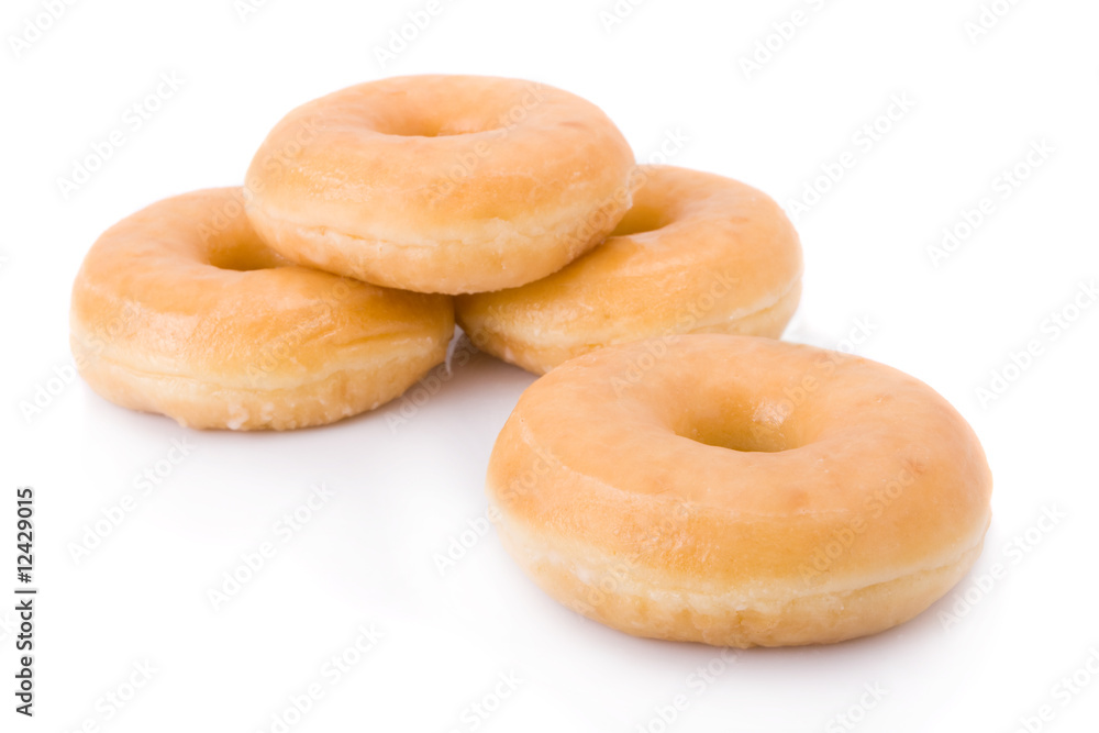 Four doughnuts or donuts piled isolated on white.