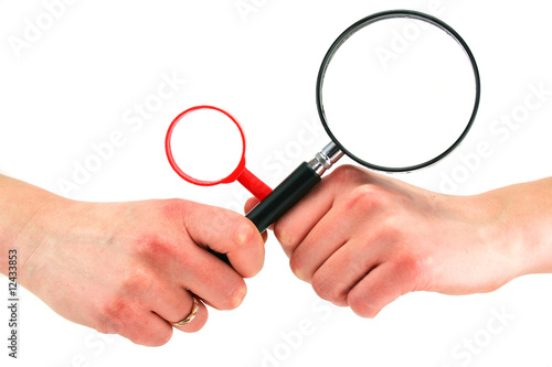 Woman's hands holds two magnifying glasses isolated