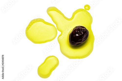 black olive on splashed olive oil drops photo