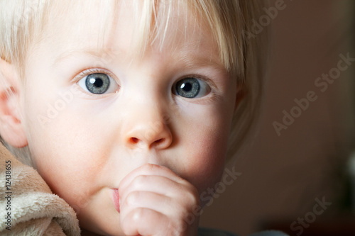 Young child sucking her thumb.