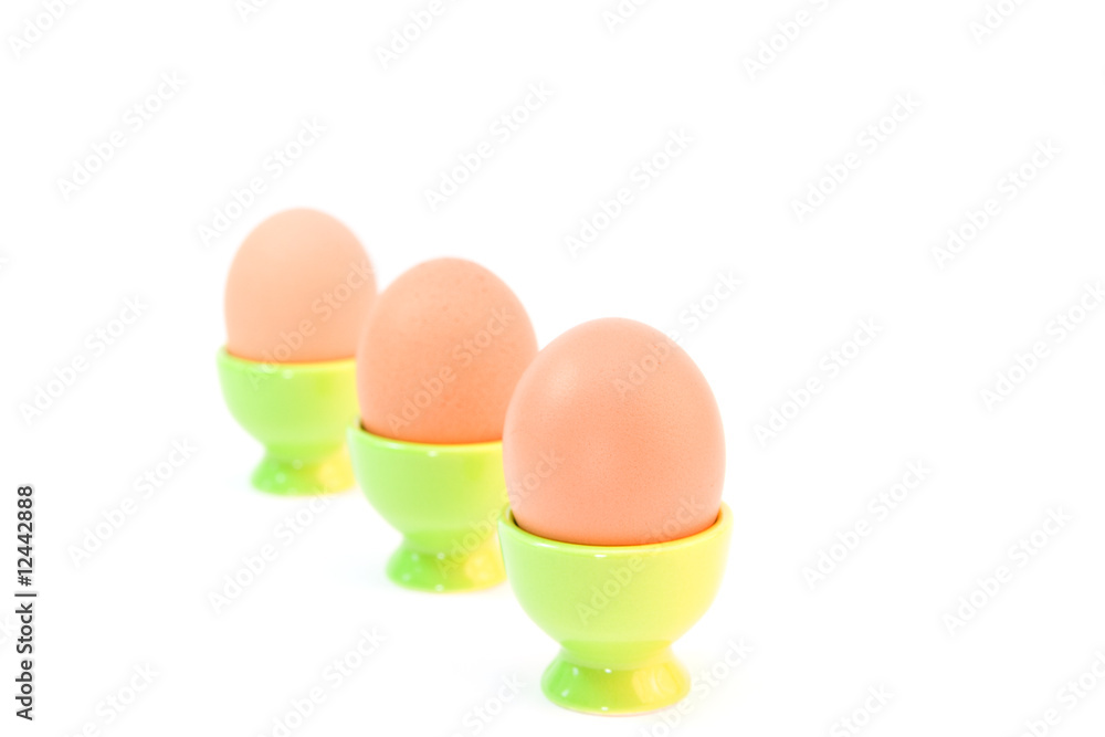 eggs in eggcups isolated on white. easter eggs in eggcups isolated on white. easter