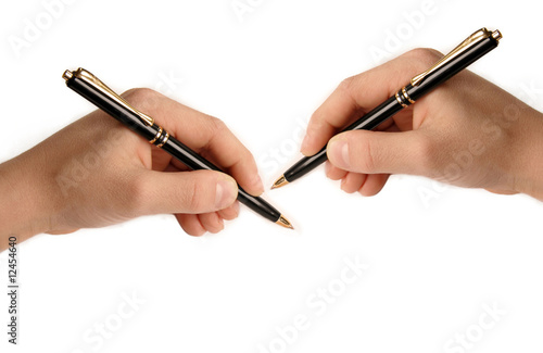 Two hands writing on white paper