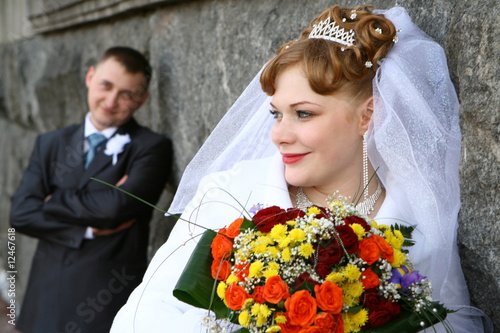 A couple near a stone wall photo