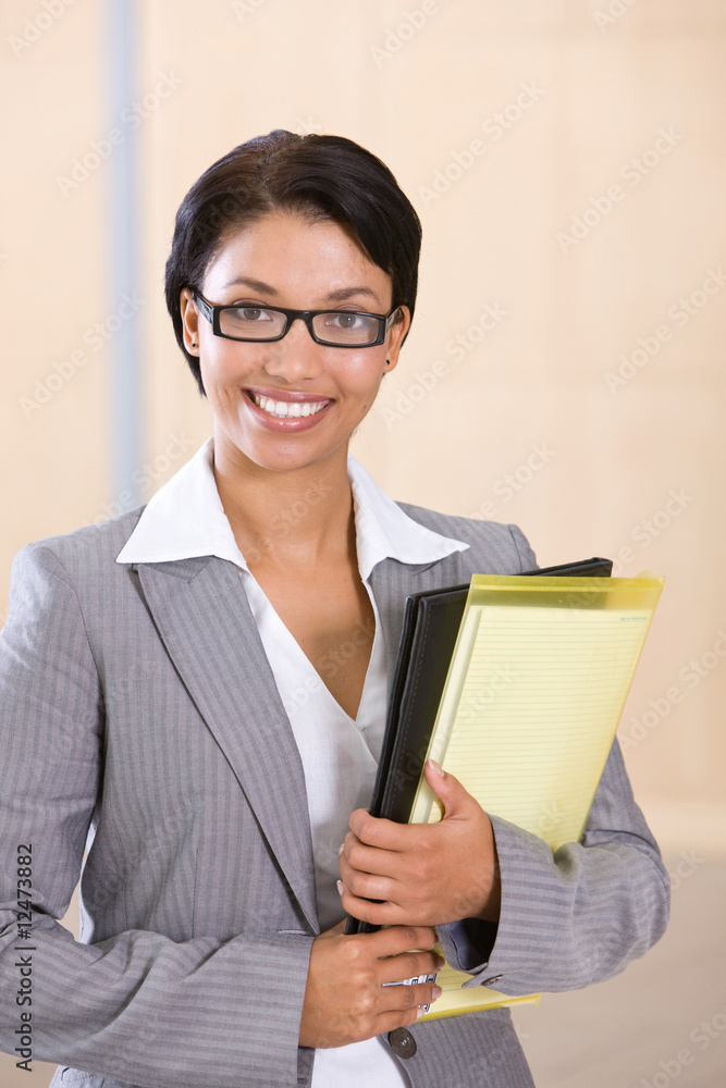 Portrait of a smiling businesswoman holding folder Portrait of a smiling businesswoman holding folder