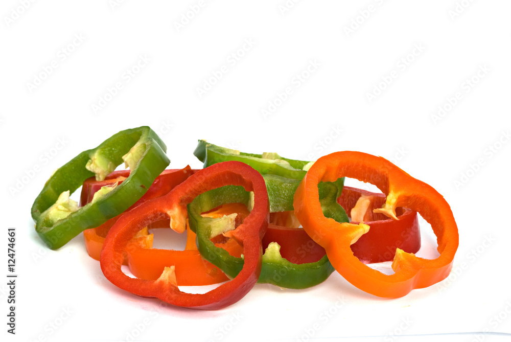 Longitudinal sections of green, yellow and red sweet peppers iso Longitudinal sections of green, yellow and red sweet peppers iso