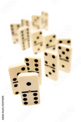 Dominoes standing on white background