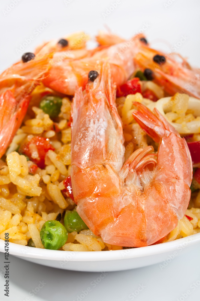 Spanish paella in a white bowl close-up