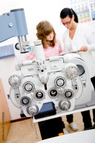 Beautiful young doctor inspect a patient in ophthalmology labor