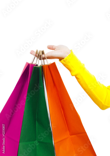woman's hand holding colorful shopping bags