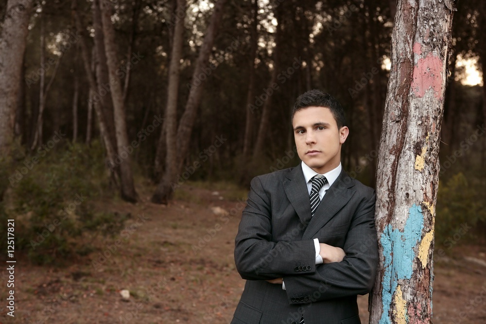 Businessman posing relaxed on a park forest Businessman posing relaxed on a park forest