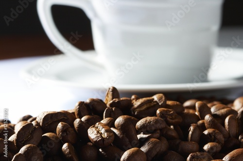 Cup with coffee, costing on coffee grain