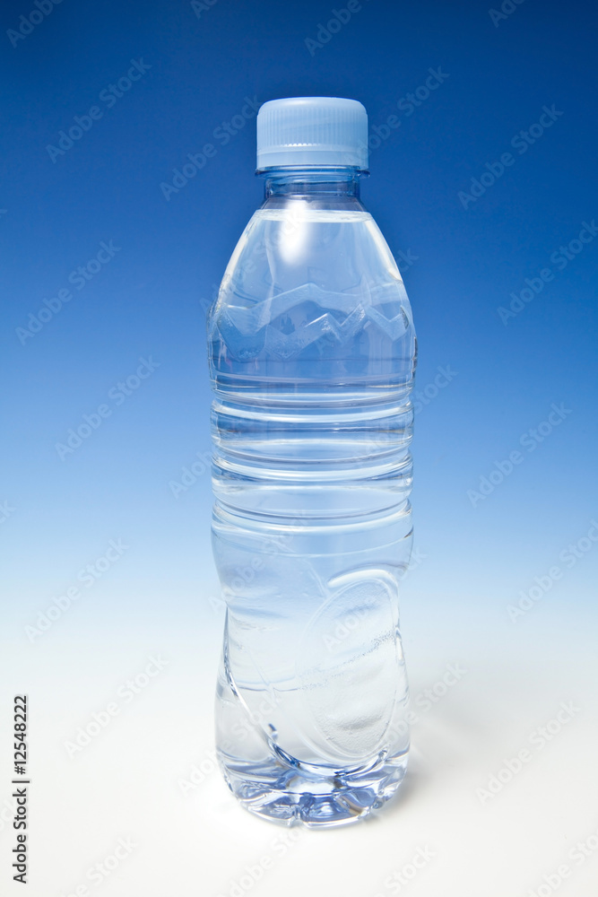 Bottled water on a graduated blue studio background. Bottled water on a graduated blue studio background.