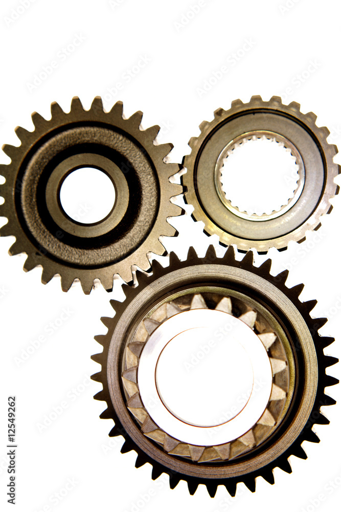 Three gears meshing together over white Three gears meshing together over white