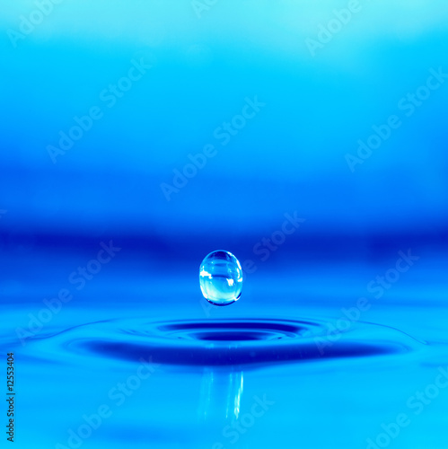 Falling drop of blue water