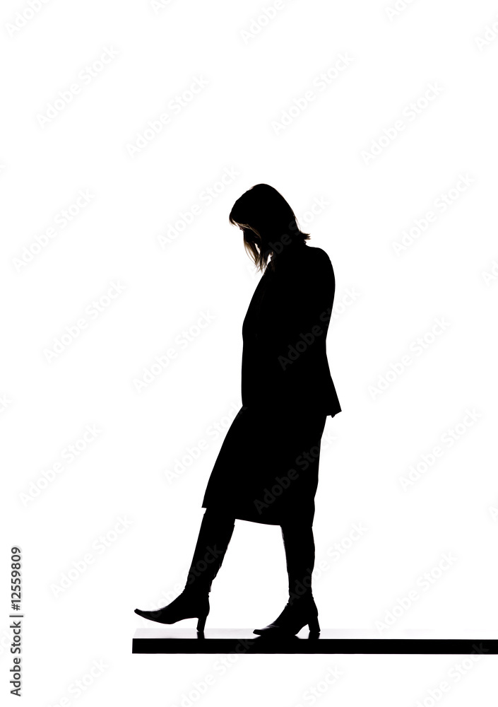 Silhouette of a woman walking on a board