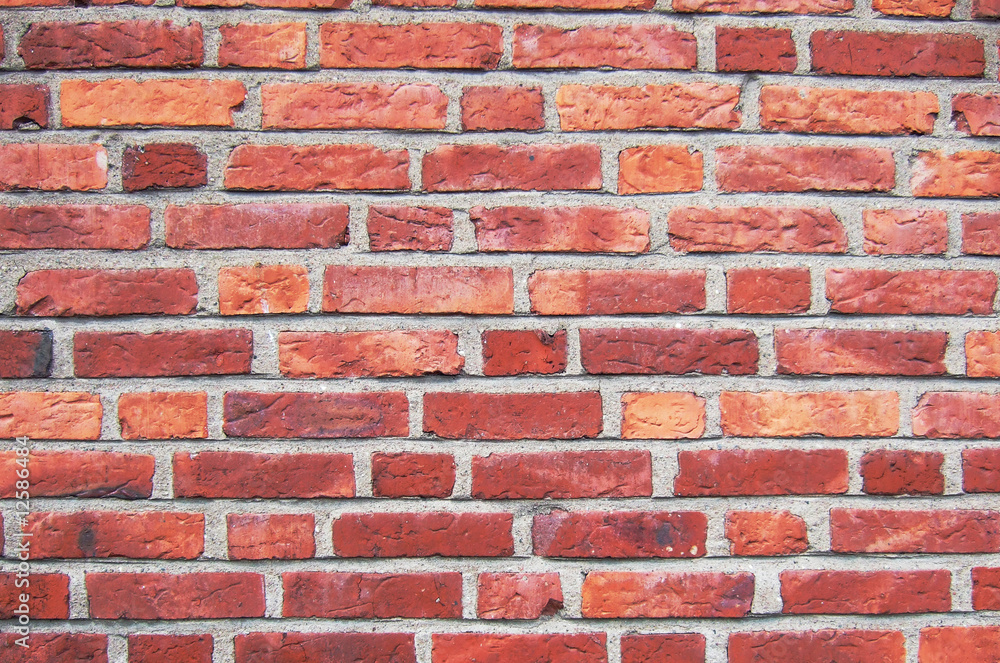 A close up of a red brickwall wtih grey plaster A close up of a red brickwall wtih grey plaster