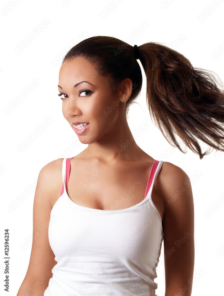 Young black woman swinging pony tail smiling Young black woman swinging pony tail smiling
