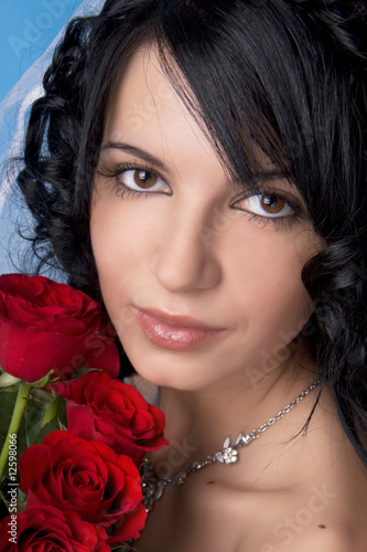 Brunette bride with red roses photo