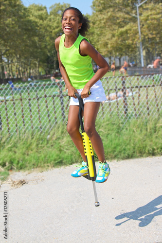 Girl jumping on pogo stick photo