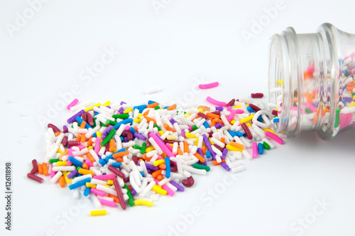 Spilled sprinkles isolated on white.