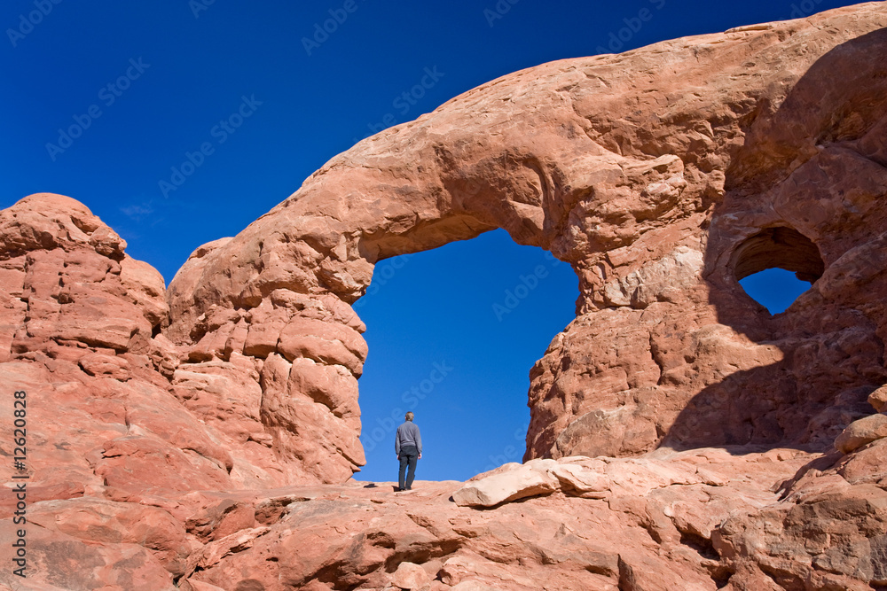 Hiker admiring natural wonders of Arches National park