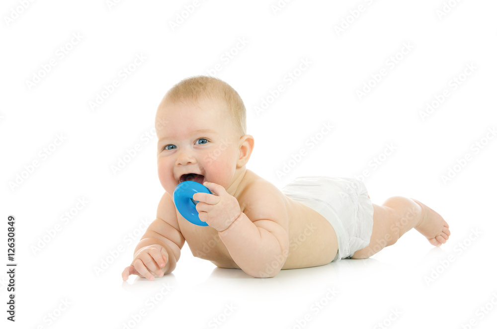 Laying small baby with a toy isolated Laying small baby with a toy isolated