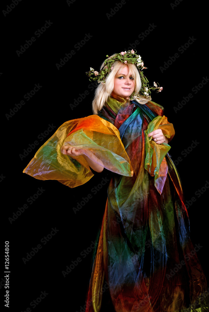 blond woman wrapped in colorful silk wearing wreath