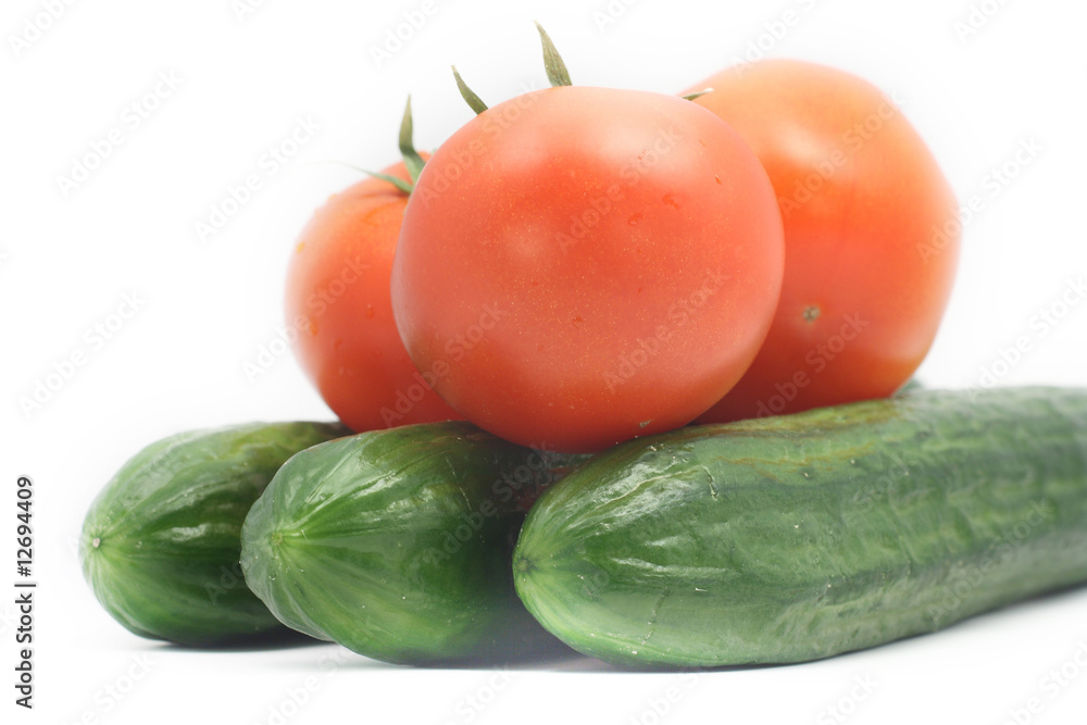 Cucumbers and tomatoes on white