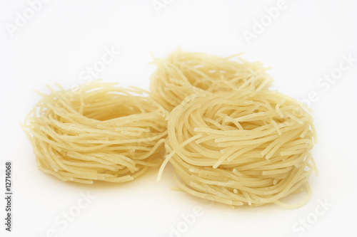 Raw pasta nests on white