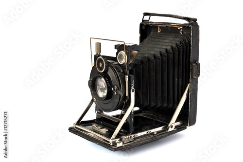 Ancient photographic camera with lens of bellows over white