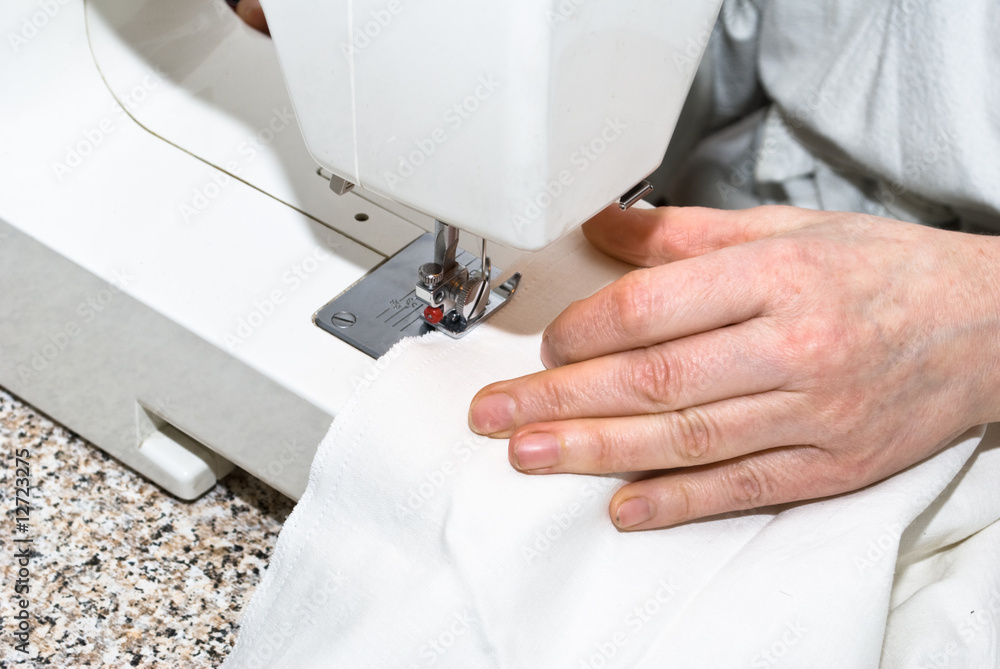 Naklejka premium Hand sewing on a machine