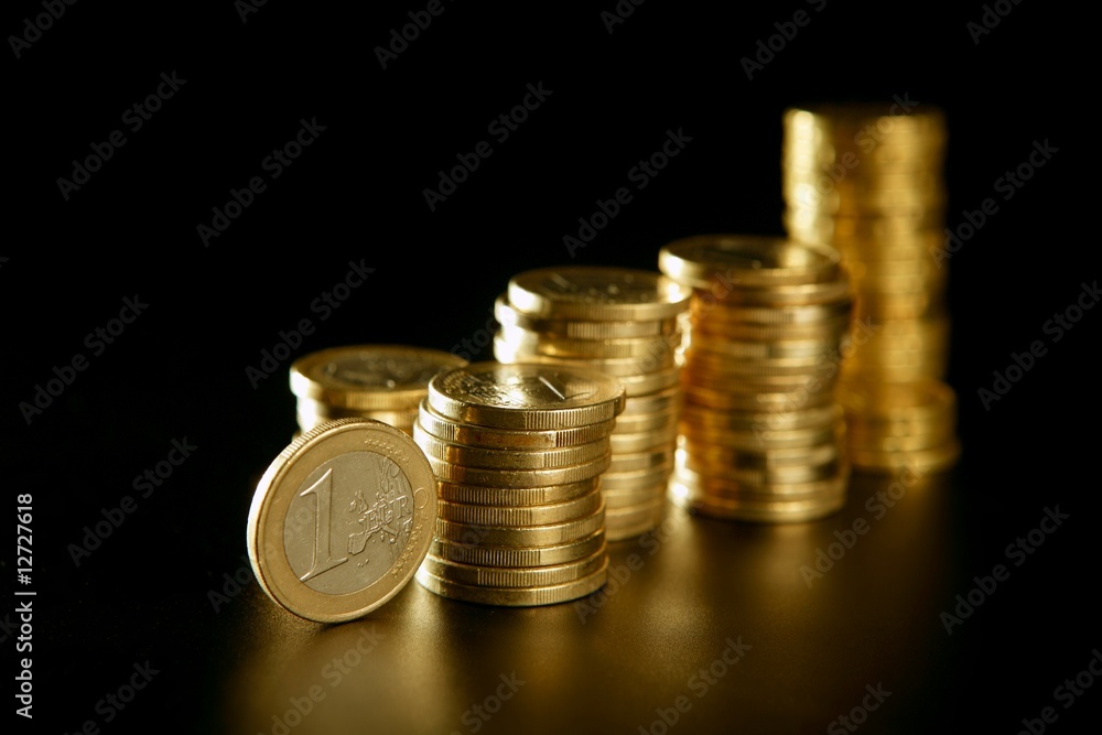 Euro currency coin columns with golden reflections Euro currency coin columns with golden reflections
