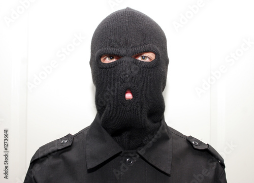an burglar wearing a ski mask (balaclava)