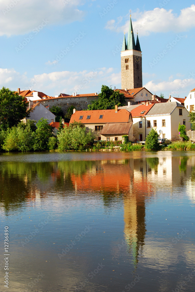 Tower and Houses with Lake Reflection