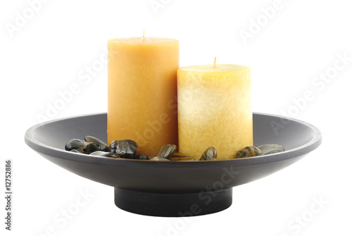 Plate with candle and rocks isolated