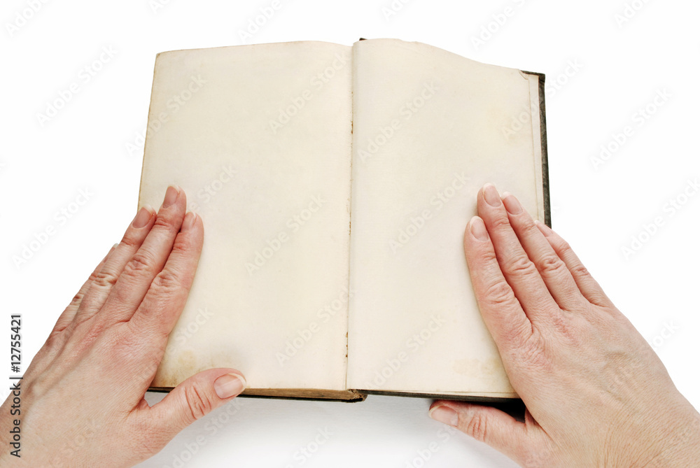 Woman hands on open book with blank pages Woman hands on open book with blank pages
