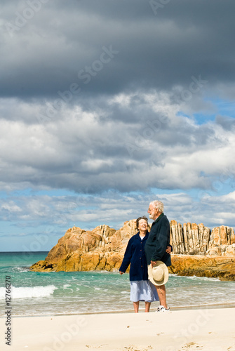 Senior Couple at Beach with Storm-clouds Gathering