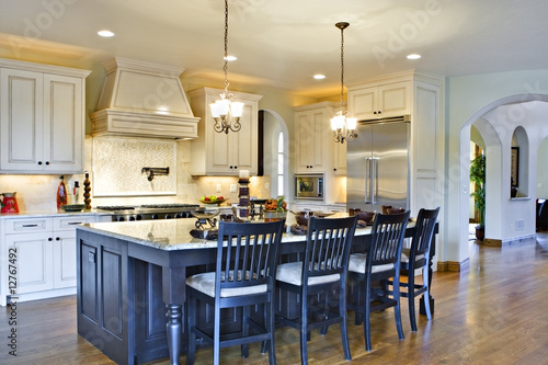 Kitchen with Center Island and View of Hallway