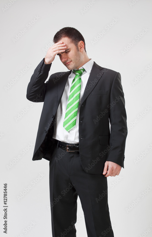 stressed businessman with his hand to his head stressed businessman with his hand to his head