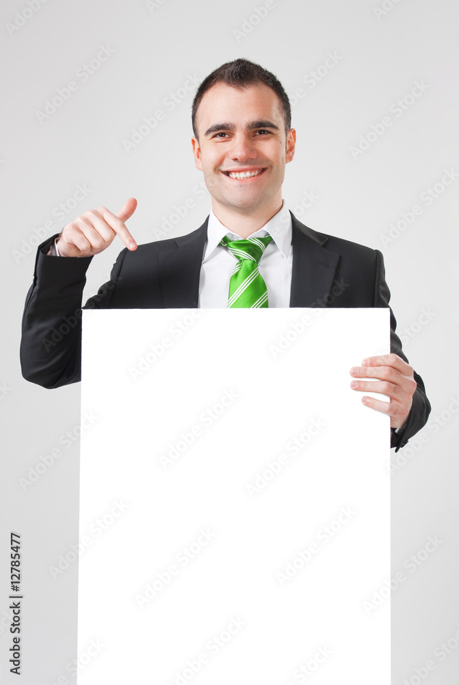 smiling businessman pointing to blank white board smiling businessman pointing to blank white board
