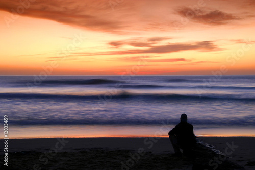 man alone watching sunset
