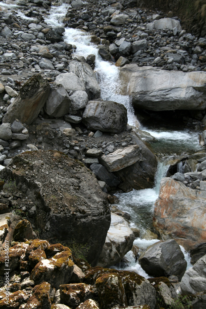 Water running down the hill through rocky terrain Water running down the hill through rocky terrain
