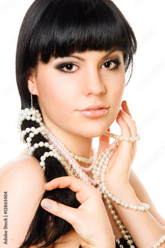 Close-up portrait of a brunette woman with pearl beads